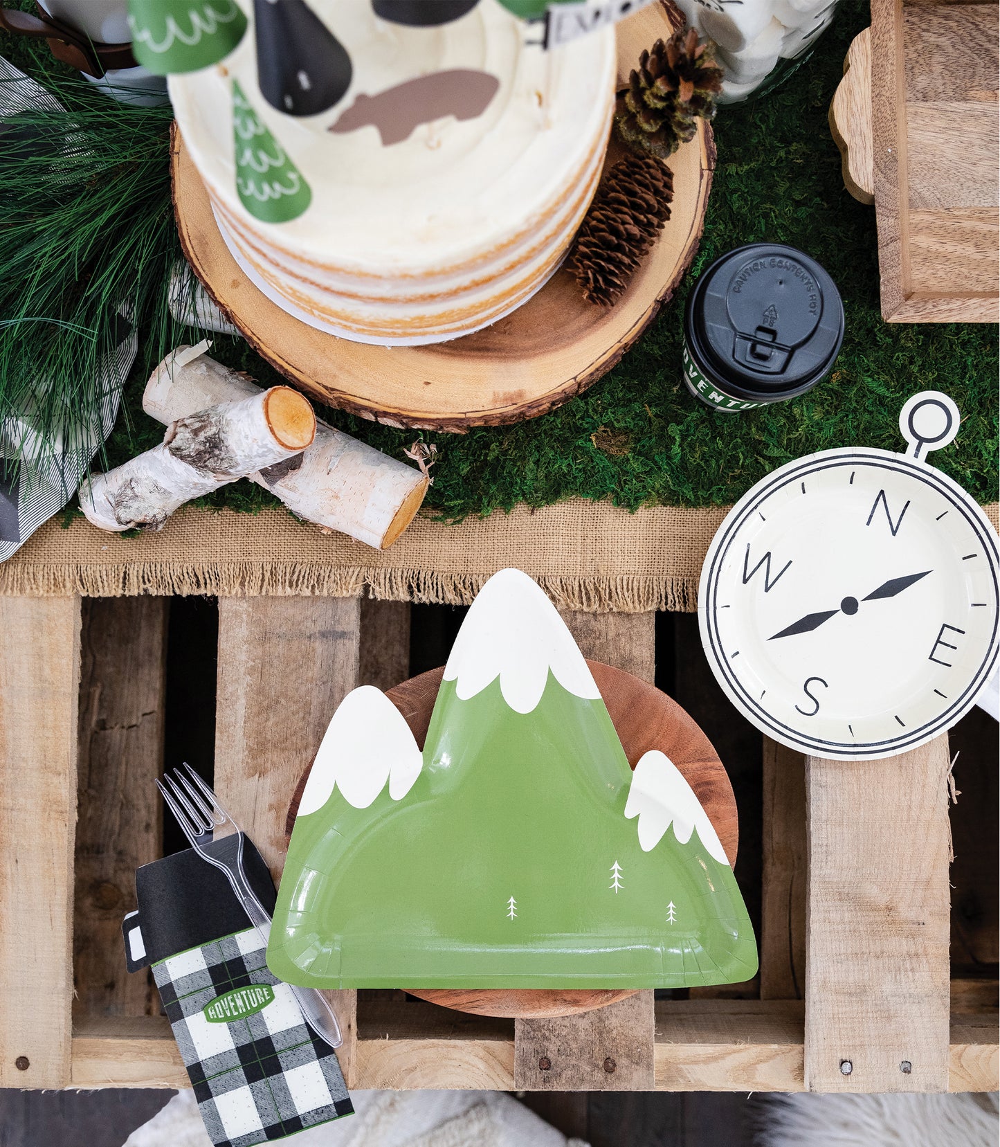 Mountain shaped paper plates. With a green base and white (snow)mountain tops. Set of 8 per pack Part of the Adventure/ Happy Camper Party